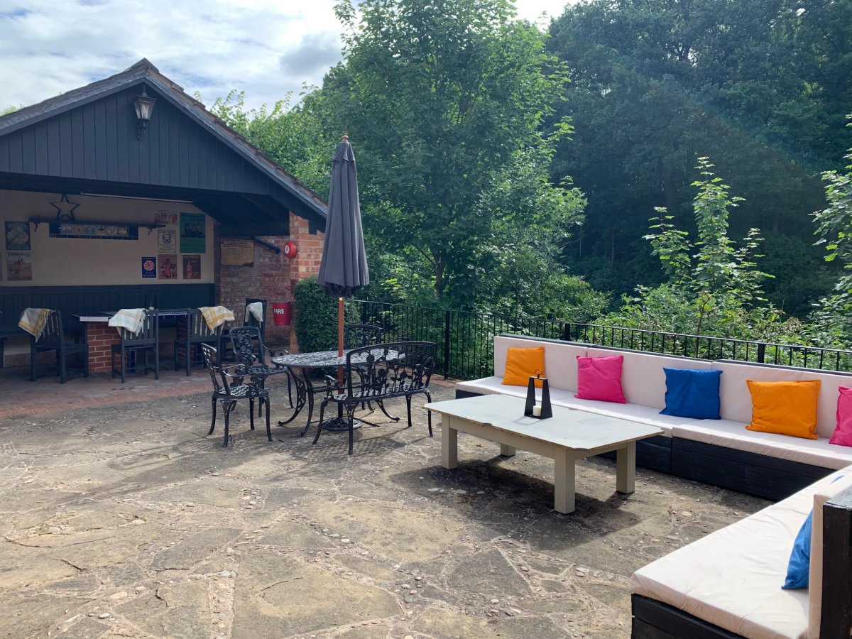 Rear terrace with lots of seating at Woodside House